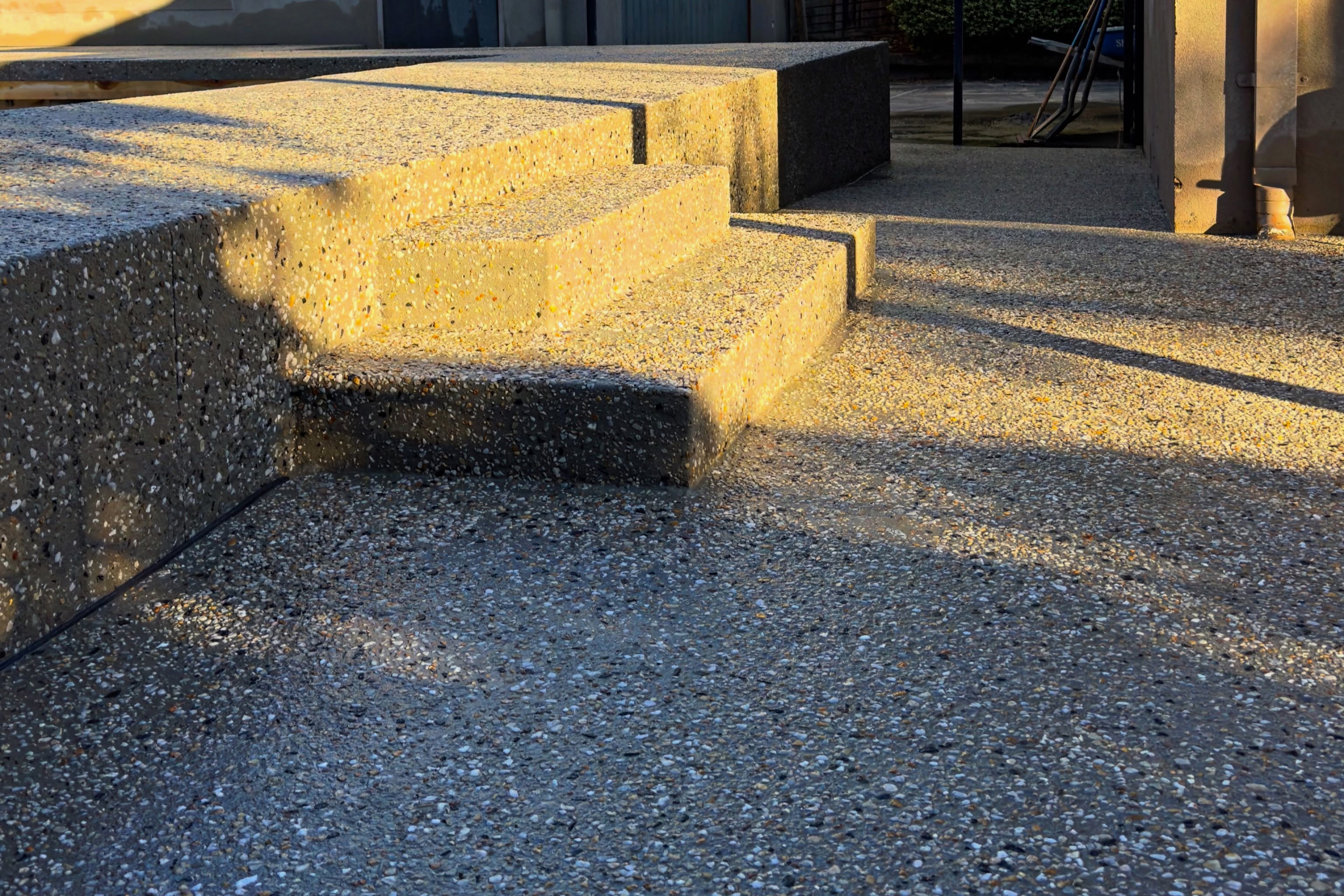 ground steps made out of dark aggregate concrete